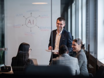 Diverse business team in a modern office during a meeting, discussing artificial intelligence compliance