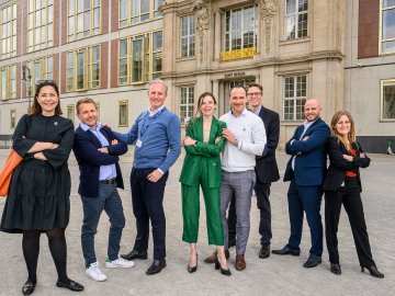 Executive MBA students posing in front of ESMT's building in Berlin, Germany.