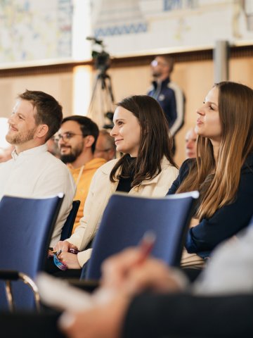 Audience members smiling